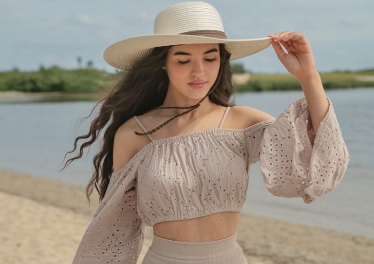 A natural-looking young woman wearing a beach outfit made from lightweight, flowing fabrics. Theme beach outfits