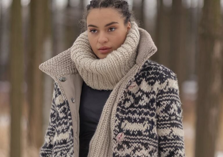 A natural-looking young woman wearing cozy leggings styled with a scarf and statement winter outerwear. Theme legging outfits winter
