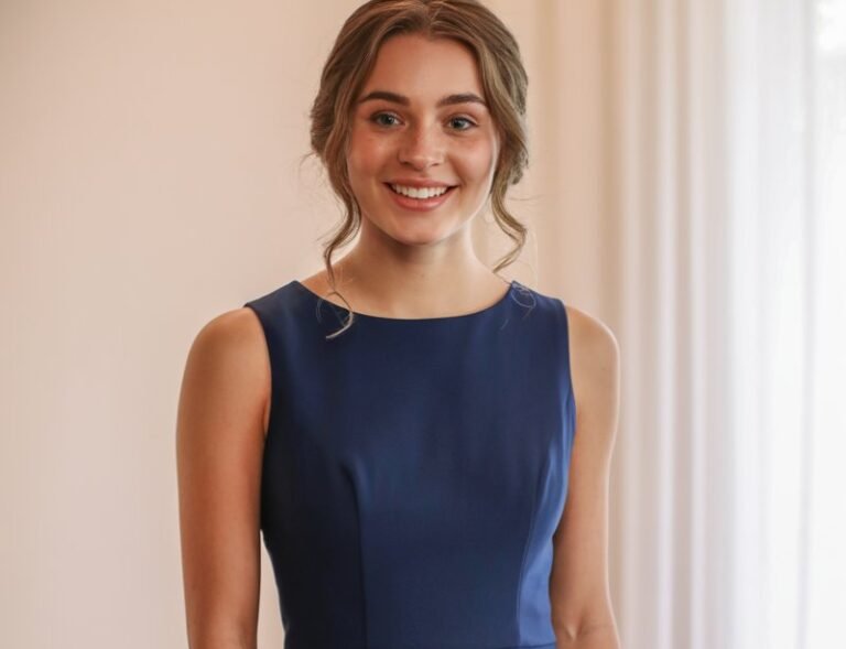 A natural-looking young woman wearing a solid-colored fit-and-flare dress with a timeless silhouette. Theme family photo outfits
