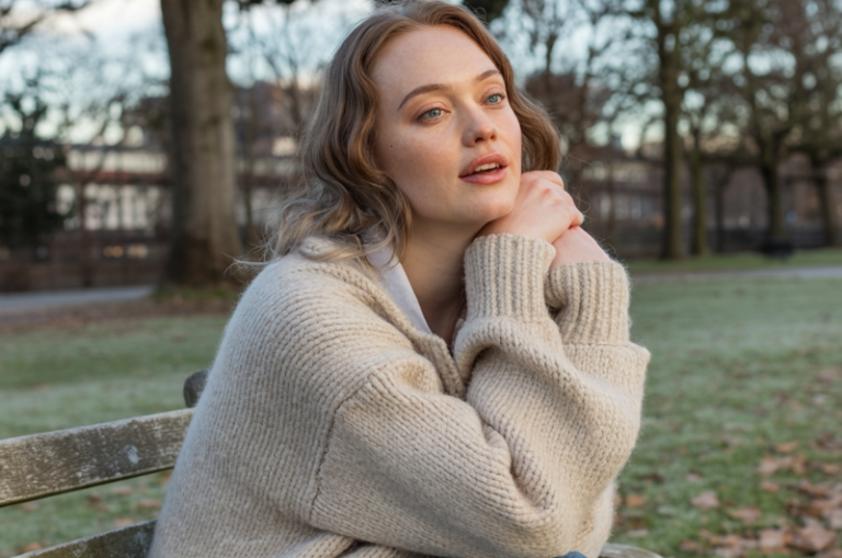 Layer a chunky cardigan over a denim skirt and boots