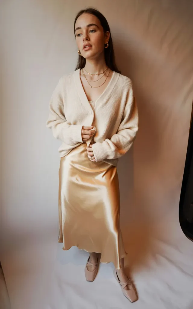 Layer a lightweight cardigan over a satin slip skirt
