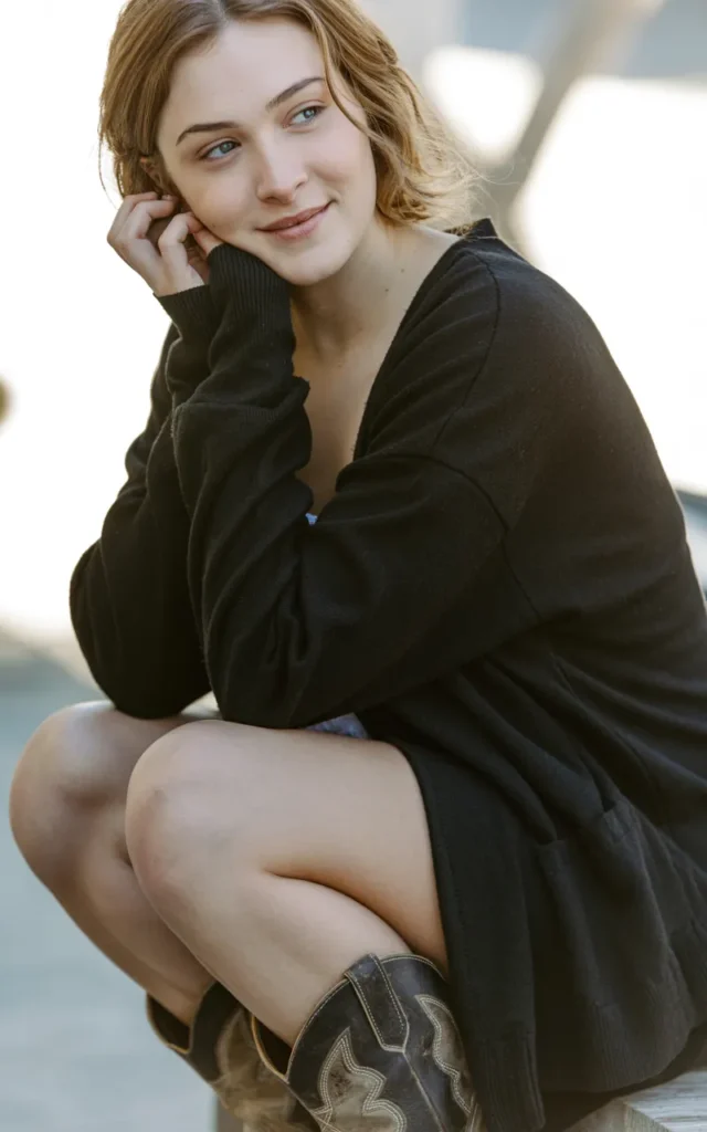 Pair a black cardigan with a mini skirt and boots