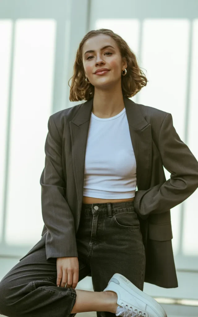 Throw a blazer over a crop top and high-waisted jeans